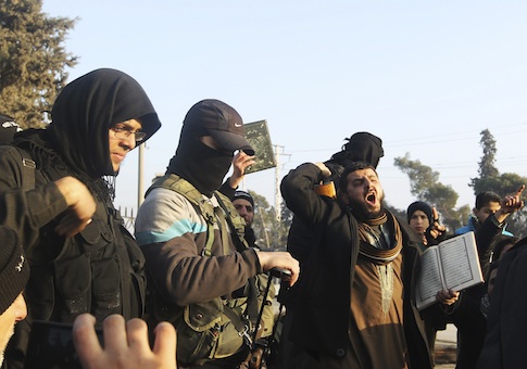 Fighters from the Islamic State in Iraq and the Levant (ISIL) try to calm civilians demonstrating against the rebel infighting in Aleppo