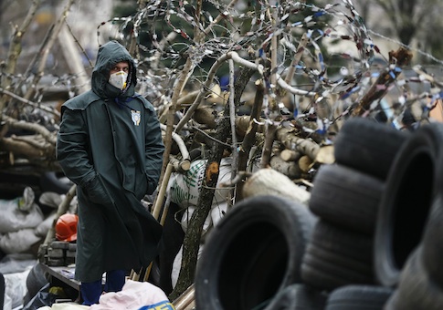 A pro-Russia protester stands at a barricade outside a regional government building in Donetsk