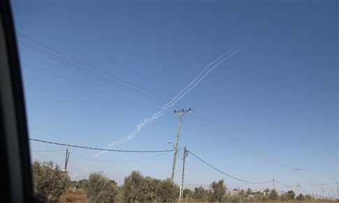 Smoke trails are seen as a rocket is launched from the east Gaza City towards Israel on August 19