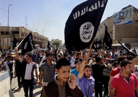 Demonstrators chant pro-al-Qaida-inspired Islamic State of Iraq and the Levant (ISIL) as they carry al-Qaida flags in front of the provincial government headquarters in Mosul