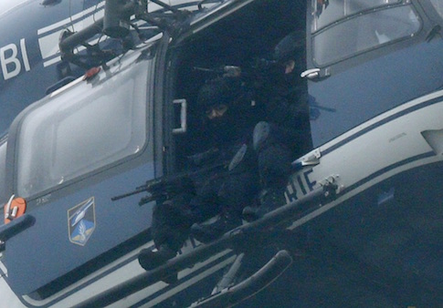 A helicopter with members of the French intervention forces hover above the scene of a hostage taking at an industrial zone in Dammartin-en-Goele, northeast of Paris January 9
