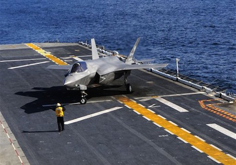 An F-35B Lightning II makes the first vertical landing on a flight deck at sea aboard the amphibious assault ship USS Wasp
