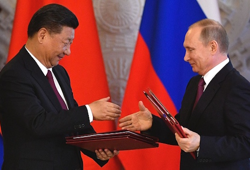 Russian President Vladimir Putin and Chinese counterpart Xi Jinping shake hands