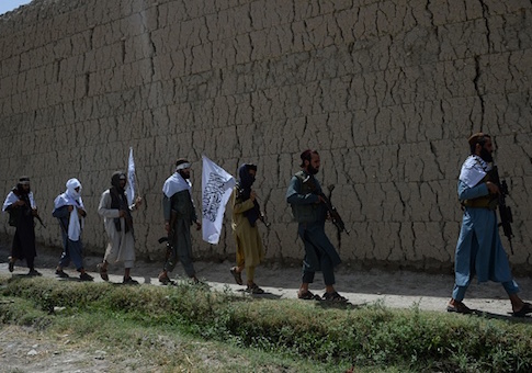 Afghan Taliban militants walk as they took to the street to celebrate ceasefire