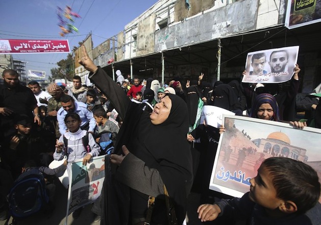 A Palestinian woman scatters sweets as she celebrates with others an attack on a Jerusalem synagogue, in Rafah in the southern Gaza Strip November 18, 2014. Two Palestinians armed with a meat cleaver and a gun killed four people in a Jerusalem synagogue on Tuesday before being shot dead by police, the deadliest such incident in six years in the holy city amid a surge in religious conflict