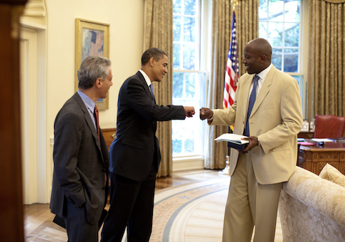 President Barack Obama gives a fist-bump to Personal Aide Reggie Love