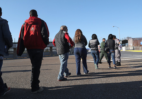 Immigrants are deported across an international bridge into Mexico on March 14, 2017 from Hidalgo, Texas
