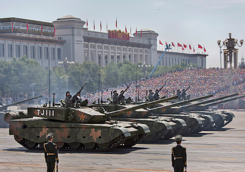 Chinese soldiers ride in tanks as they pass in front of Tiananmen Square and the Forbidden City during a military parade