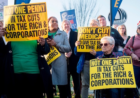 Demonstrators against the Republican tax reform bill hold a protest rally