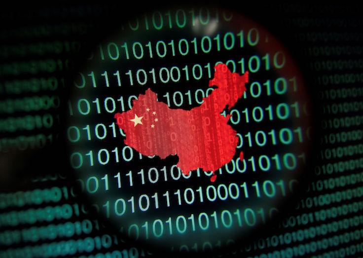 FILE PHOTO: A map of China is seen through a magnifying glass on a computer screen showing binary digits in Singapore
