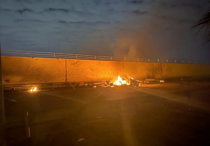Burning debris are seen on a road near Baghdad International Airport, which according to Iraqi paramilitary groups were caused by three rockets hitting the airport in Iraq