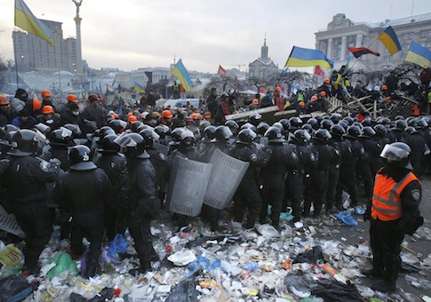 Pro-European Union activists wave flags as riot police pull back from Independence Square