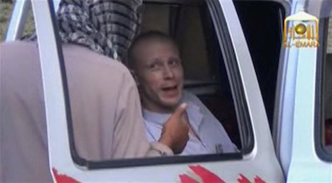 U.S. Army Sergeant Bowe Bergdahl (R) talks to a Taliban militant as he waits in a pick-up truck before his release at the Afghan border