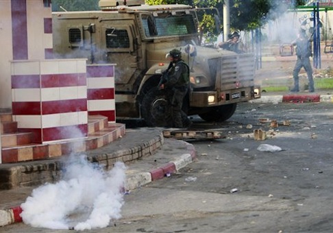 Israeli army soldiers take positions during clashes with Palestinians in the early morning in the West Bank city of Jenin on July 2