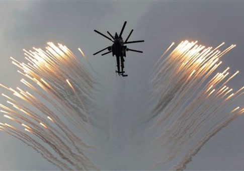 a couple of Russian Army helicopters fly over the Monument to Scuttled Ships, during a promotional campaign for contract service for Russian Army in Sevastopol, Crimea, Saturday, Dec. 20