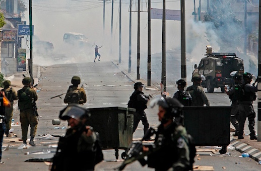 Tear gas fumes billow during clashes between Palestinian protesters and Israeli forces