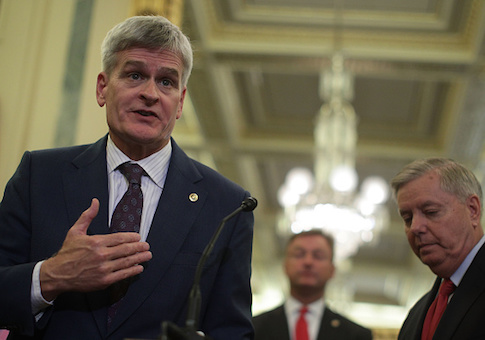 Sen. Bill Cassidy speaks as Sen. Dean Heller and Sen. Lindsey Graham listen during a news conference on health care