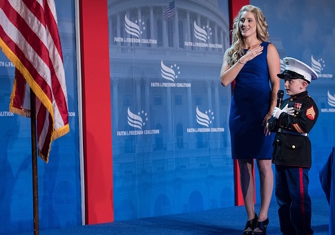 Six-year-old Christian Jacobs says the Pledge of Allegiance with his mother Brittany Jacobs / Getty Images