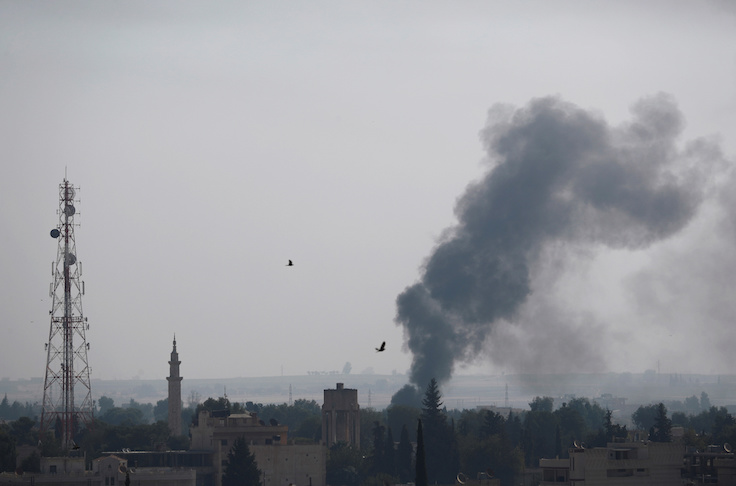 Smoke rises over the Syrian town of Ras al-Ain, as seen from the Turkish border town of Ceylanpinar, Sanliurfa province