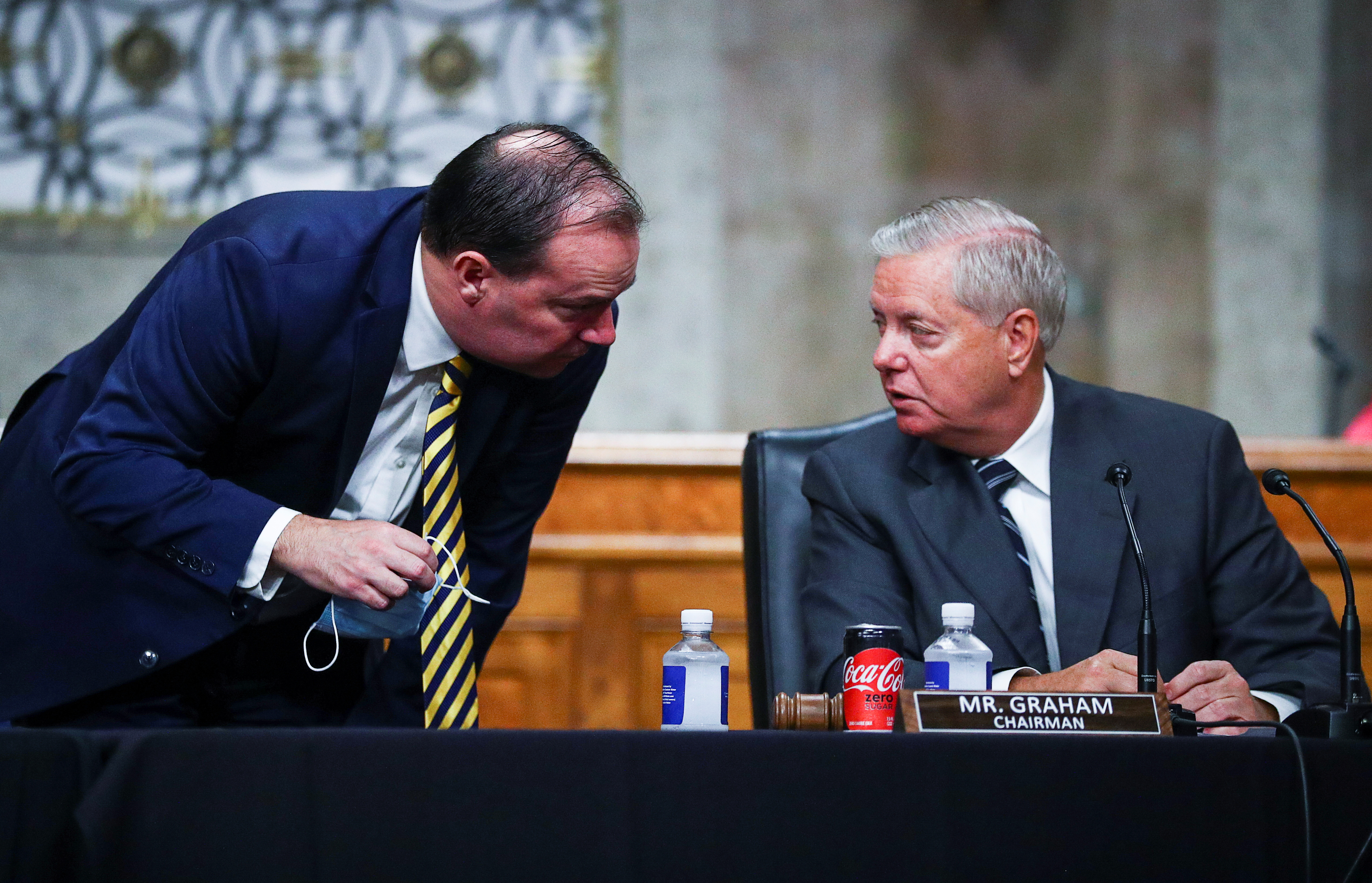 Senator Mike Lee speaks with Senate Judiciary Committee Chairman Lindsey Graham at a Senate Judiciary Committee meeting on the nomination of Judge Amy Coney Barrett
