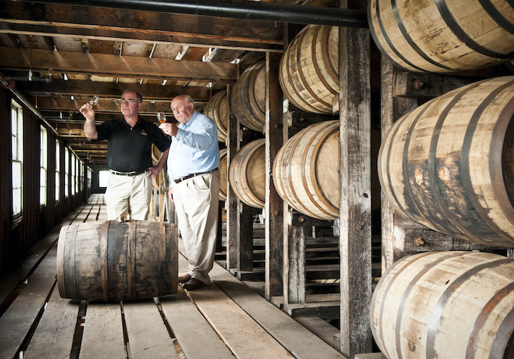 Eddie Russell and his father Jimmy sample bourbon inside Wild Turkey's rickhouse in Lawrenceburg, Ky.