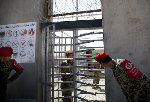 Afghan National Army soldiers peek through the gate of the Parwan Detention Facility
