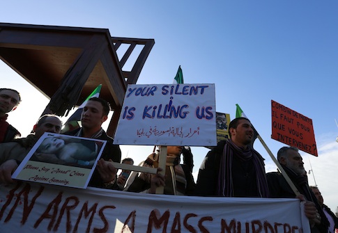 Protesters, who are against the Syrian government, demonstrate outside the United Nations building in Geneva, as international mediator Lakhdar Brahimi holds talks with a Syrian government delegation