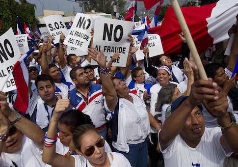 Supporters of Norman Quijano, Nationalist Republican Alliance presidential candidate, many holding posters that read in Spanish; "No to electoral fraud," demand a vote recount of Sunday's runoff election during a protest