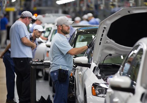 an employee at the Volkswagen plant in Chattanooga, Tenn., works on a Passat sedan