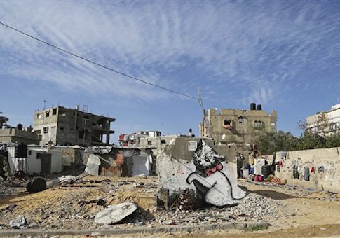 A mural of a playful-looking kitten, presumably painted by British street graffiti artist Banksy, is seen on a wall damaged in last summer's Israel-Hamas war, in Beit Hanoun, in the northern Gaza Strip, Friday, Feb. 27