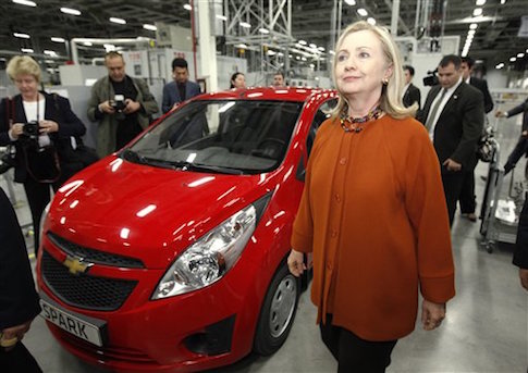 Hillary Rodham Clinton walks past a General Motors "Spark" while touring the GM Powertrain plant in Tashkent, Uzbekistan Sunday Oct. 23, 2011