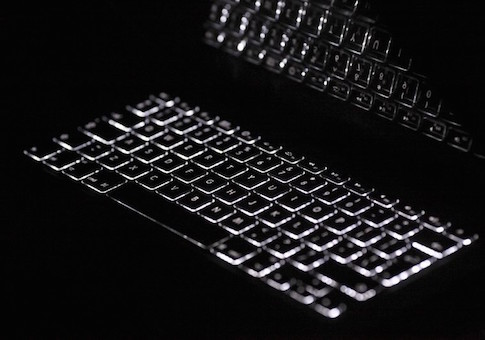 Backlit keyboard is reflected in screen of Apple Macbook Pro notebook computer