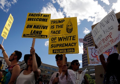 Protesters threw rocks and bottles at police officers who responded with pepper spray outside a rally for presidential candidate Donald Trump in Albuquerque, New Mexico, police said.