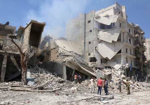 Men inspect a damaged site after double airstrikes on the rebel held Bab al-Nairab neighborhood of Aleppo