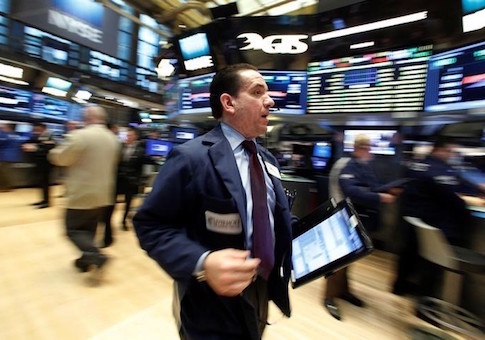 Traders work on the floor of the NYSE