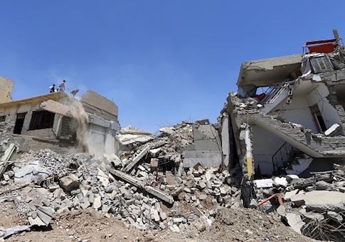 Iraqis clear the debris of a building in west Mosul