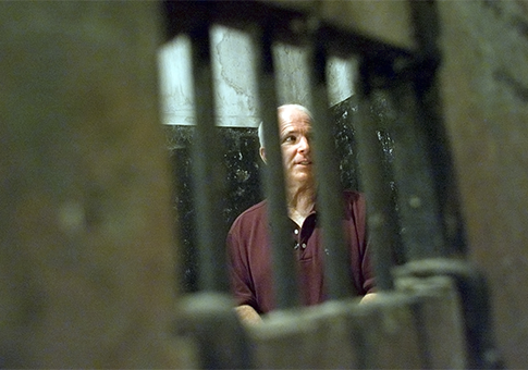 Sen. John McCain walks inside the Hoa Lo prison, nicknamed "Hanoi Hilton" / AP
