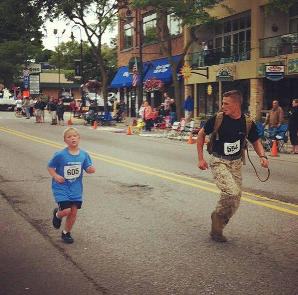 Photo: Marine Helps Young Boy Separated from Group Finish Race