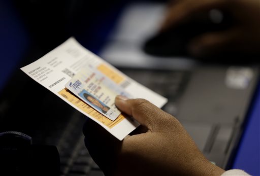 Hillary Clinton Donor at Firm With Eric Holder Among Lawyers Behind Voter ID Suit