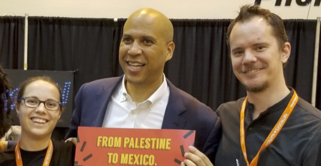 Booker Gives Lame Excuse of Him Pictured With Anti-Israel Radicals While Holding Sign Supporting Their Cause